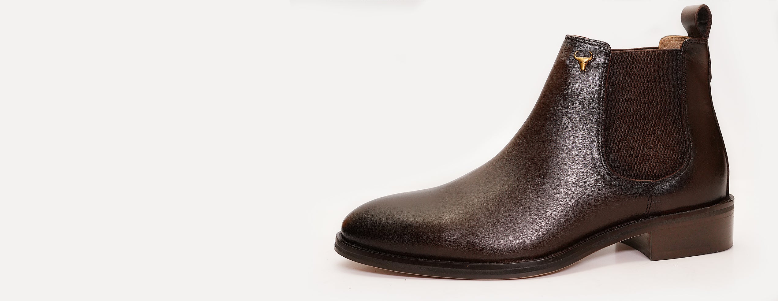 Side view of a premium handcrafted brown leather Chelsea boot by Piel Cuero featuring elastic panel and low heel design